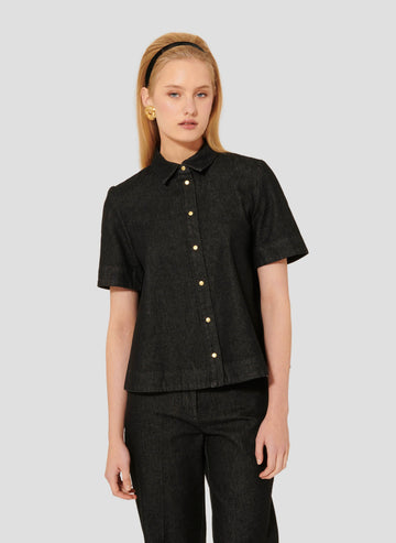 Model wearing Tara Jarmon black denim short sleeves shirt.