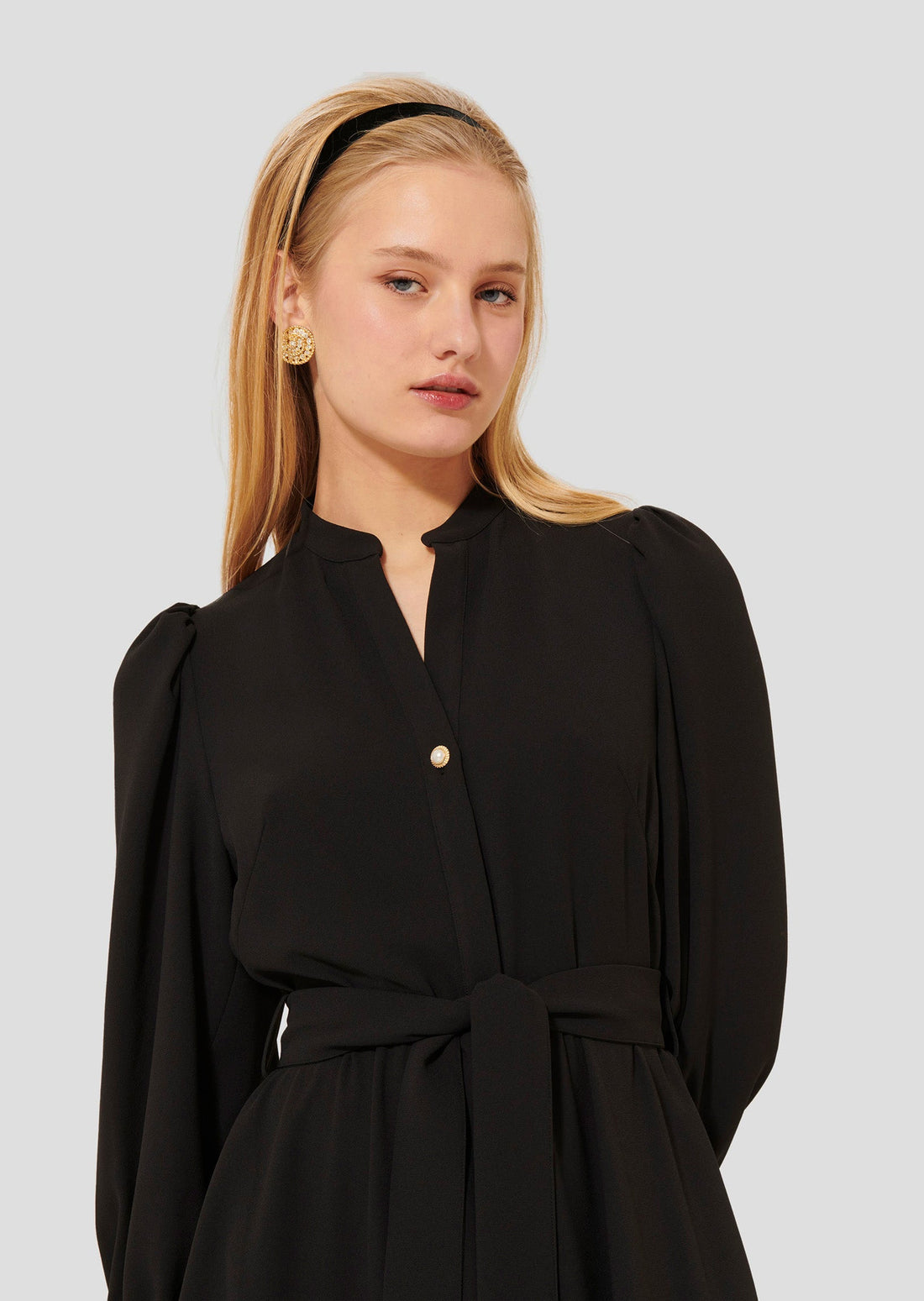 Model wearing Tara Jarmon Long-Sleeve Belted Dress in Black Crepe with adjustable waist. 