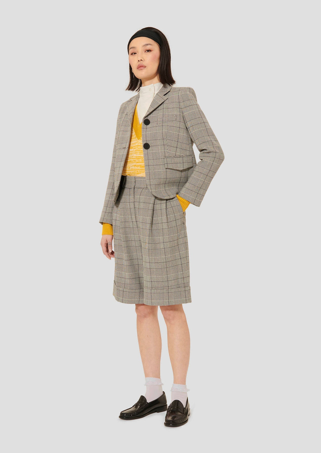 Model wearing Tara Jarmon Grey Glen Plaid Suit Jacket with Lapel Collar and Buttoned Cuffs.