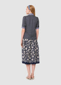 woman shown from the back wearing a Tilly midnight blue floral print top Tara Jarmon
