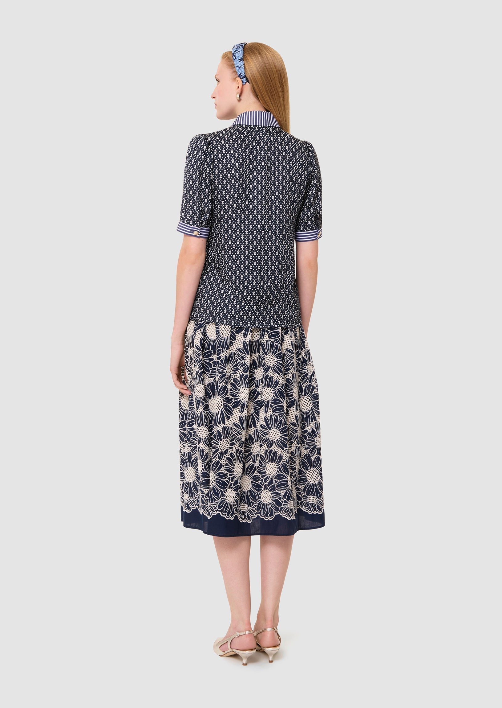 woman shown from the back wearing a Tilly midnight blue floral print top Tara Jarmon