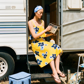 Woman in a Tara Jarmon yellow floral dress.