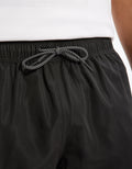 Black shorts with a drawstring on a white background