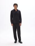 Man wearing a black shirt and pants on a white background