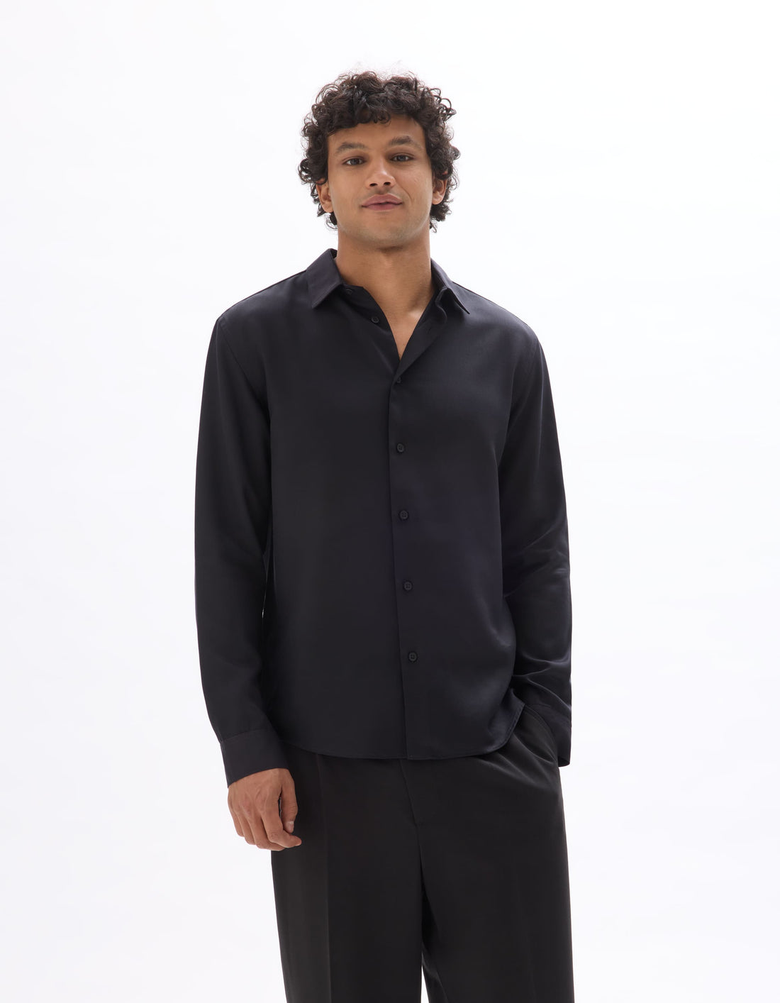 Man wearing a black shirt and pants on a white background