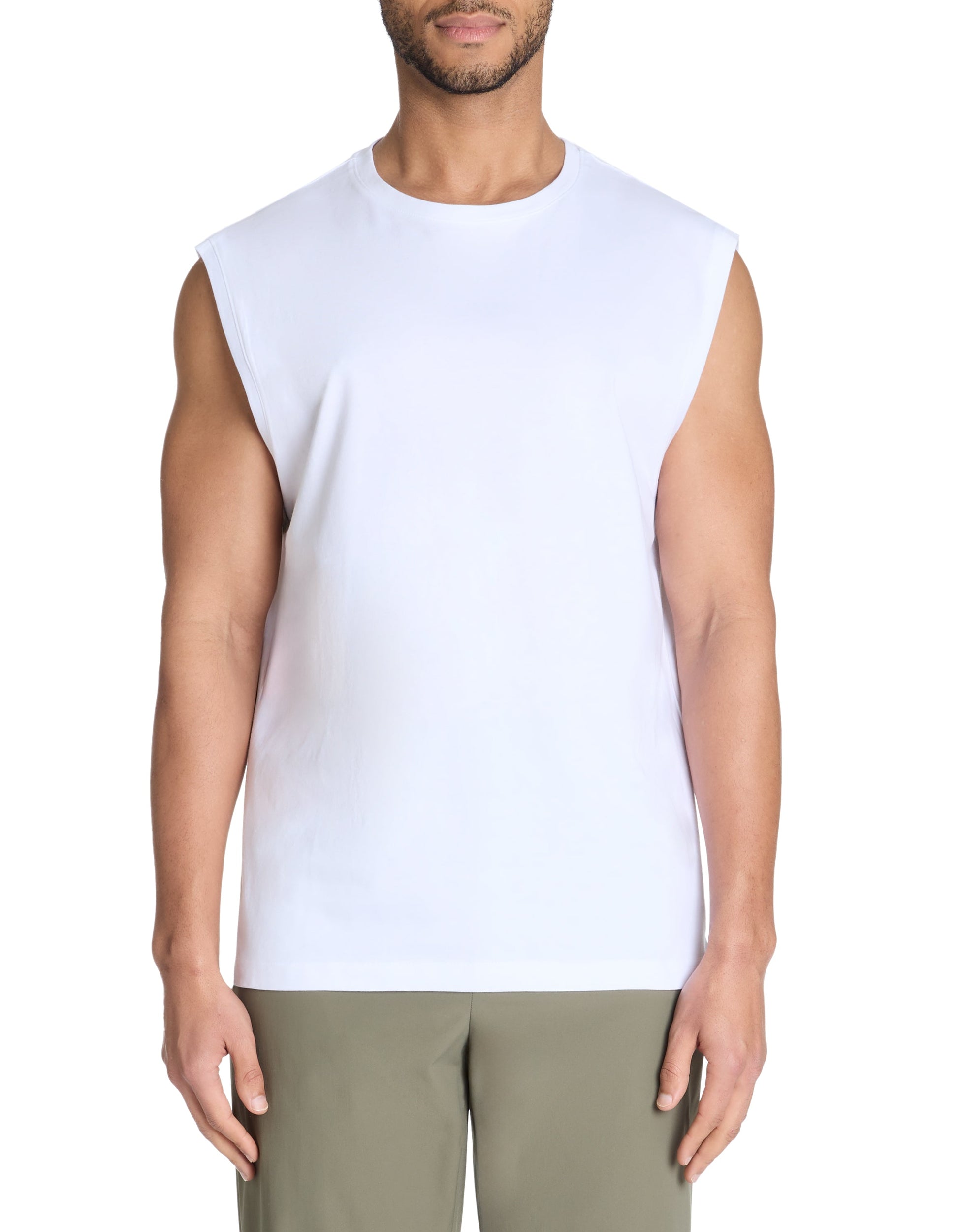 A male model wearing a white singlet and green pants.