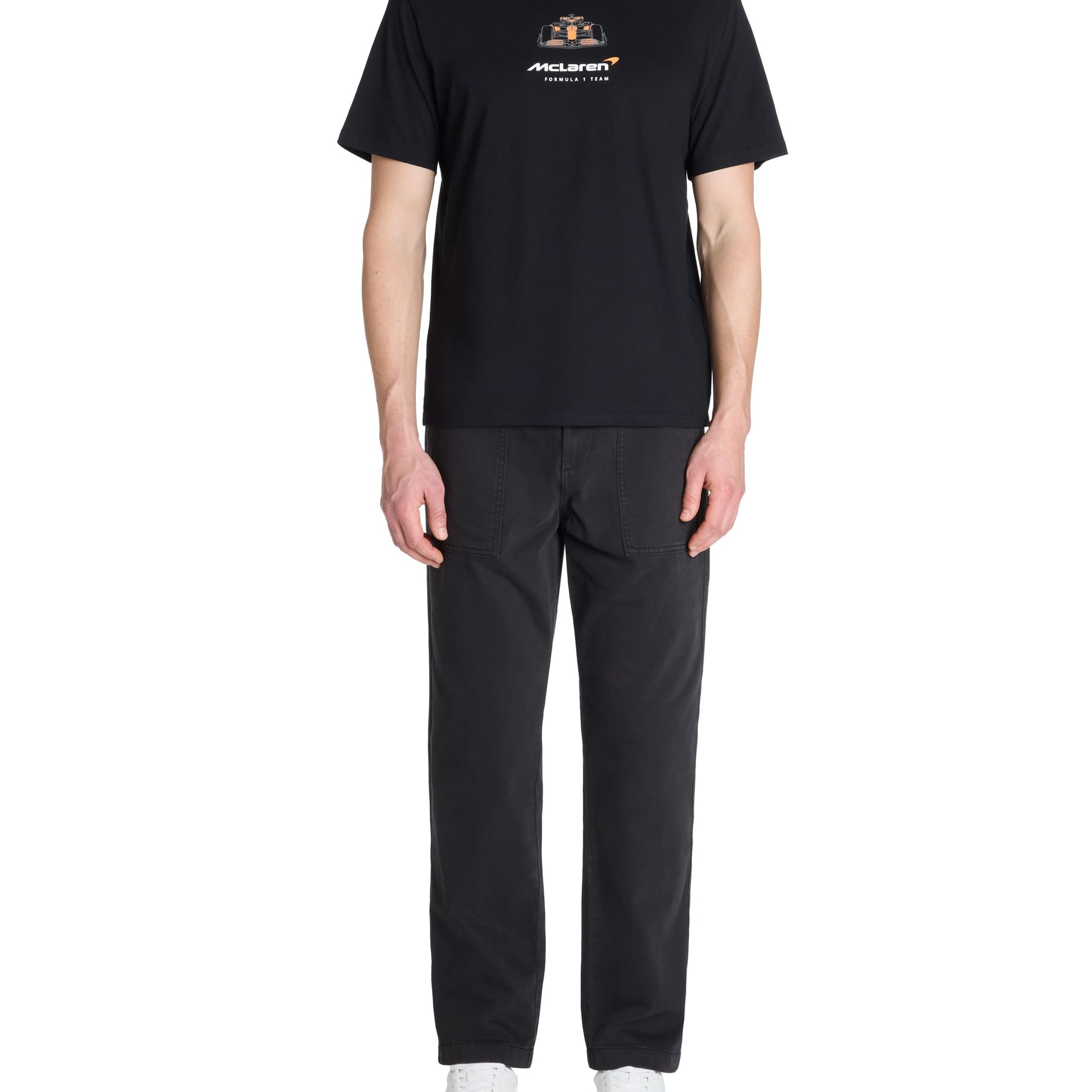 Person wearing a black t-shirt and pants with a logo on a white background