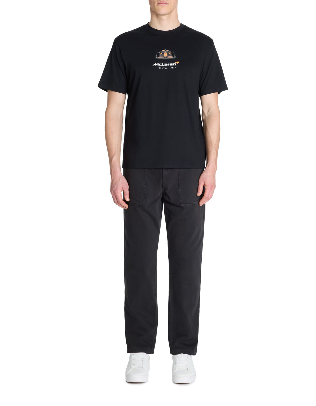 Person wearing a black t-shirt and pants with a logo on a white background