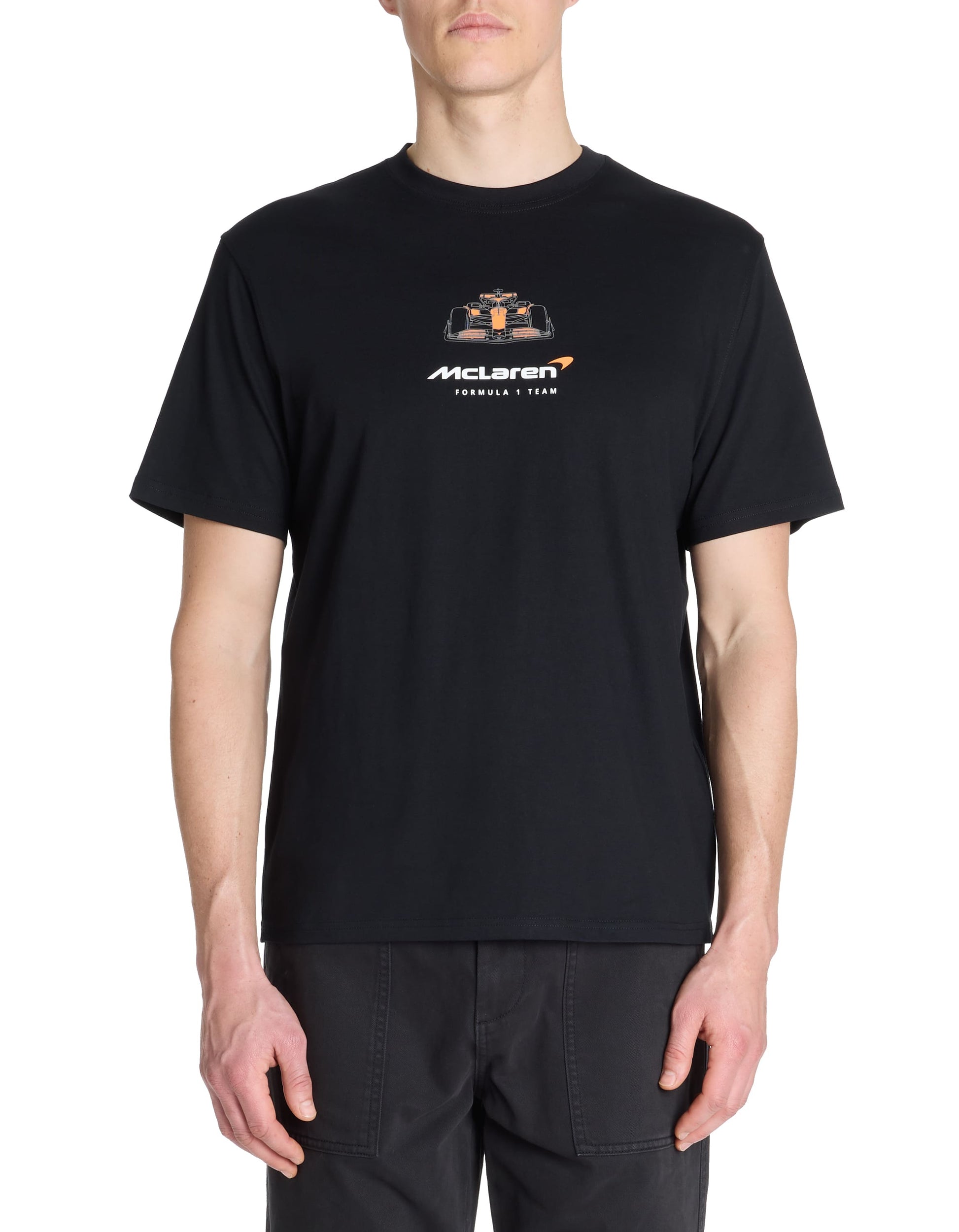 Person wearing a black t-shirt with McLaren logo on a white background
