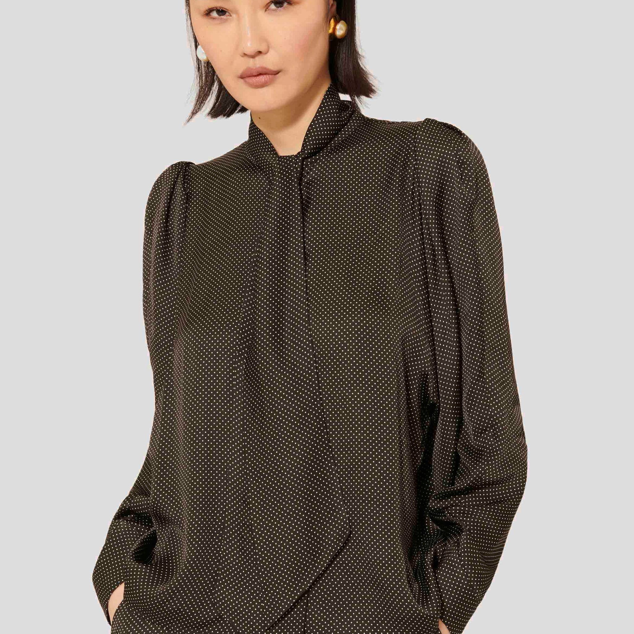 Black polka dot shirt with collar. 