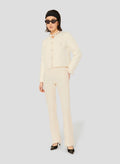 Ecru knitted cardigan with round neckline and long sleeves. 