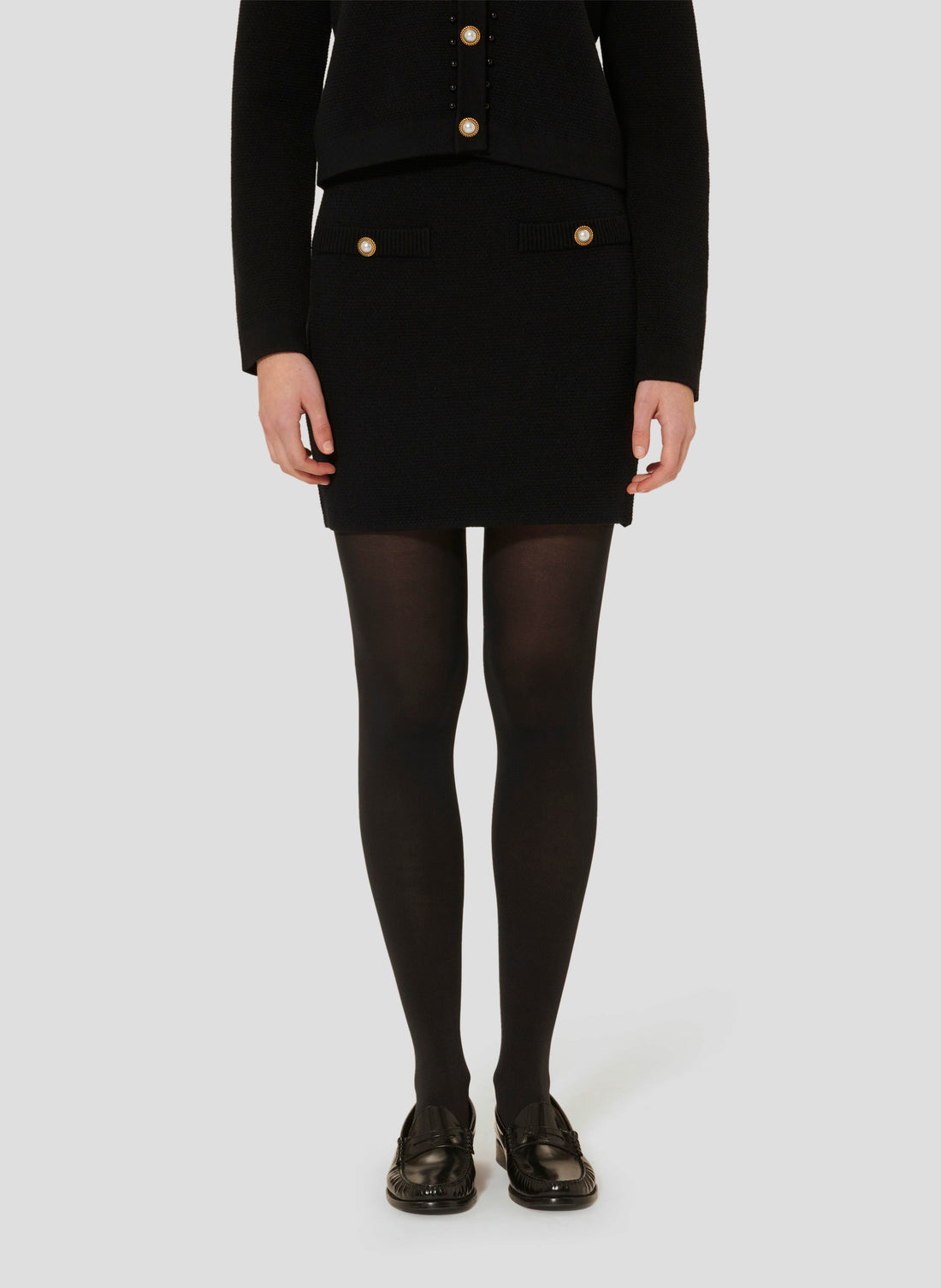 Tara Jarmon model wearing black knitted skirt 