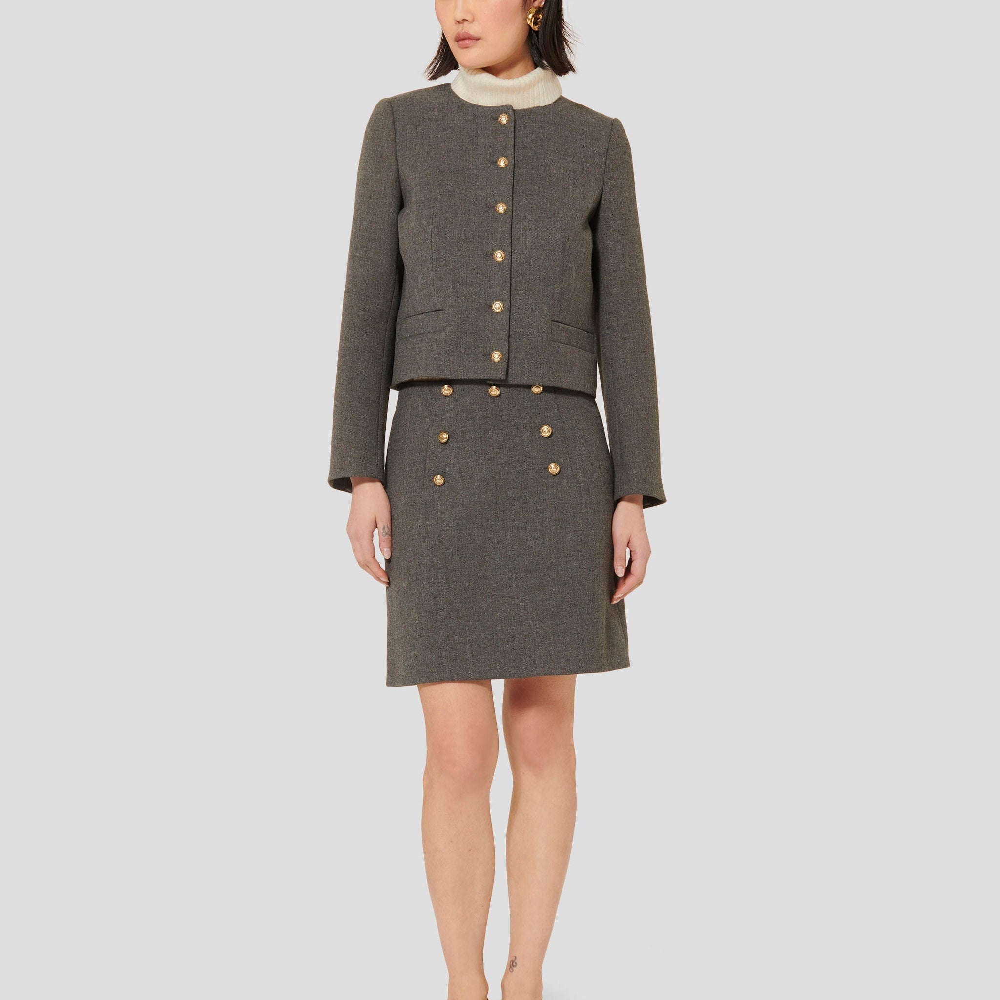 Tara Jarmon model wearing matching compact canvas grey jacket and skirt