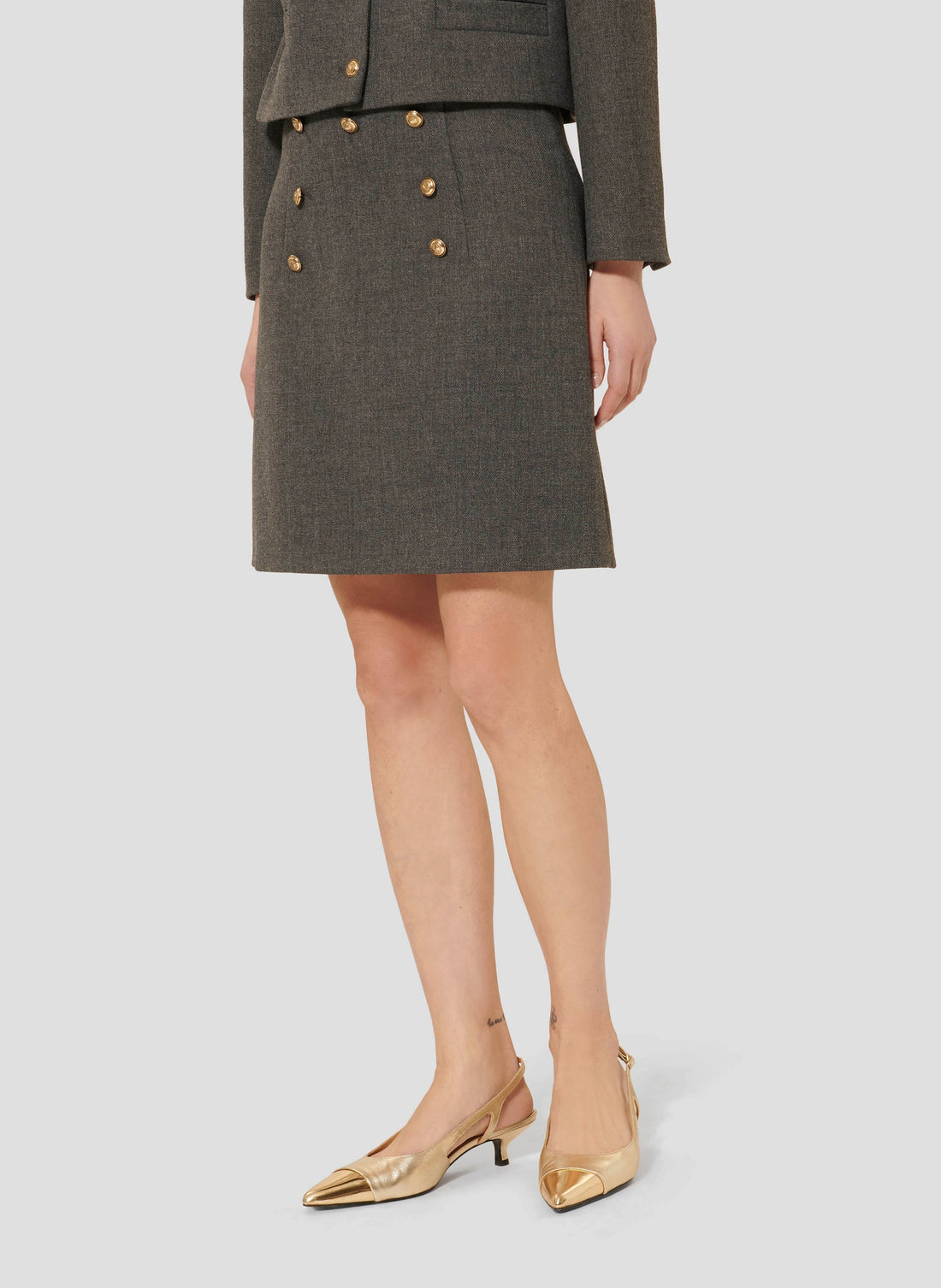 Tara Jarmon model wearing matching compact canvas grey jacket and skirt