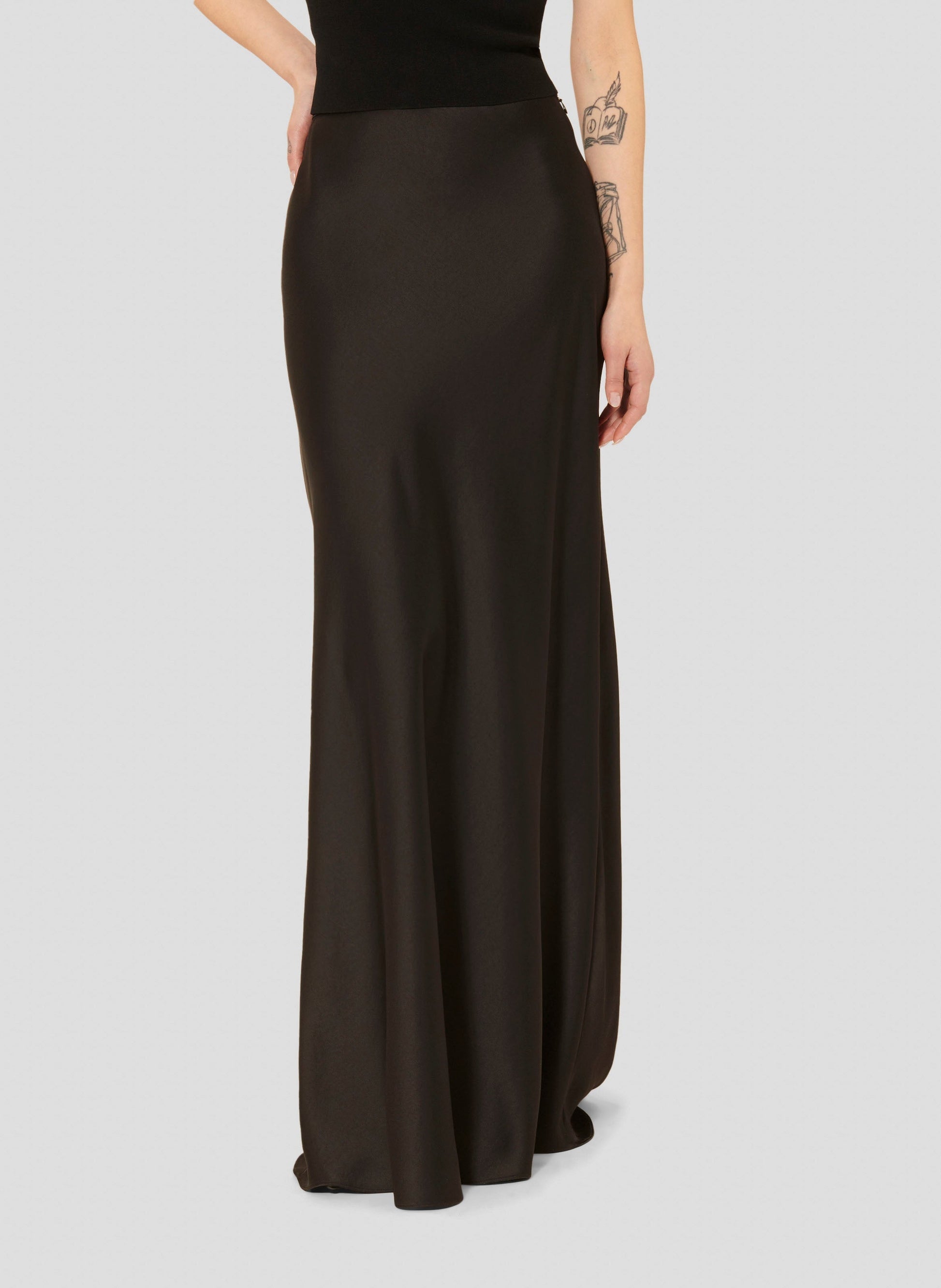 Long flowing black satin skirt.