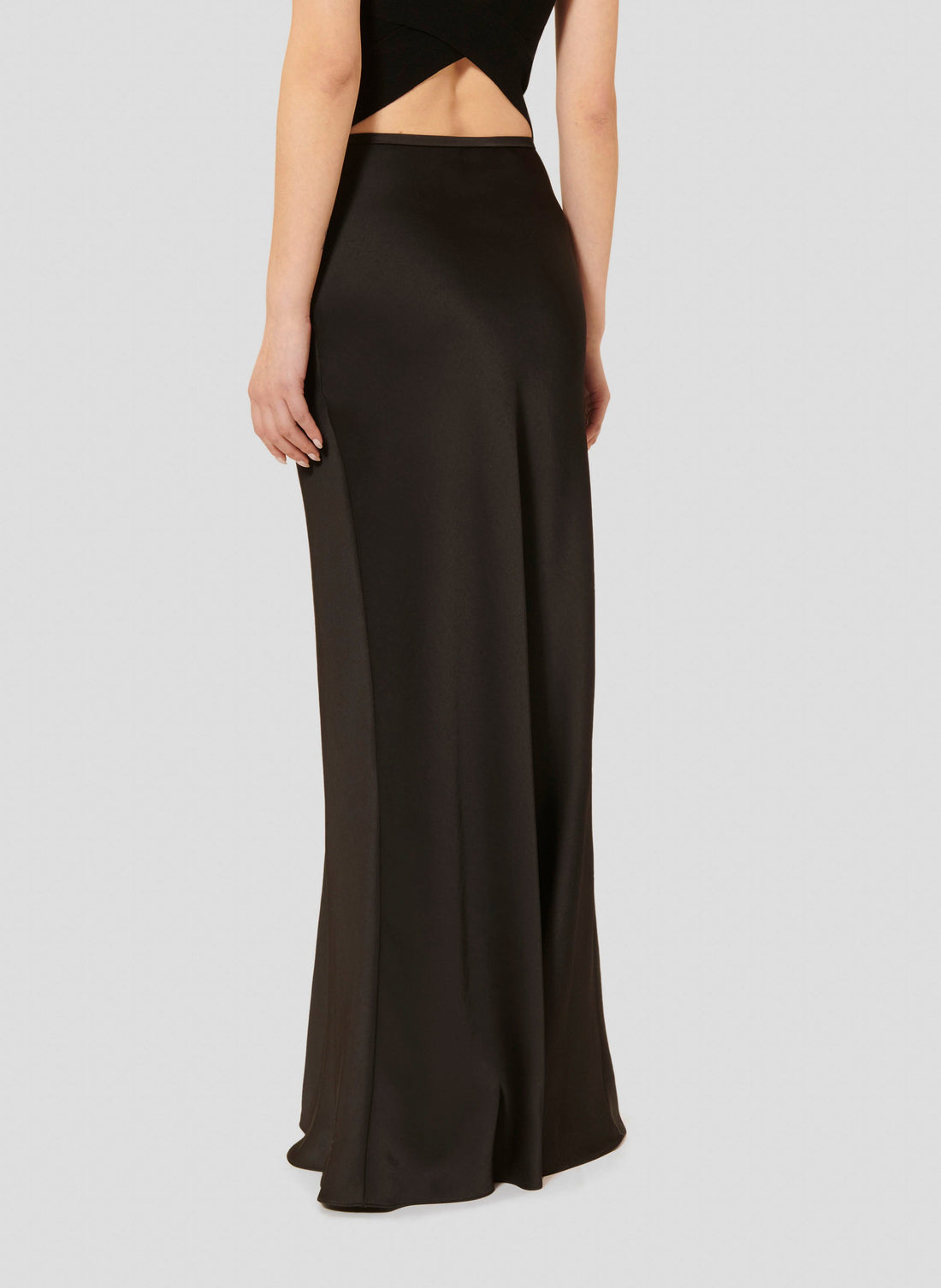 Tara Jarmon model wearing black long satin skirt