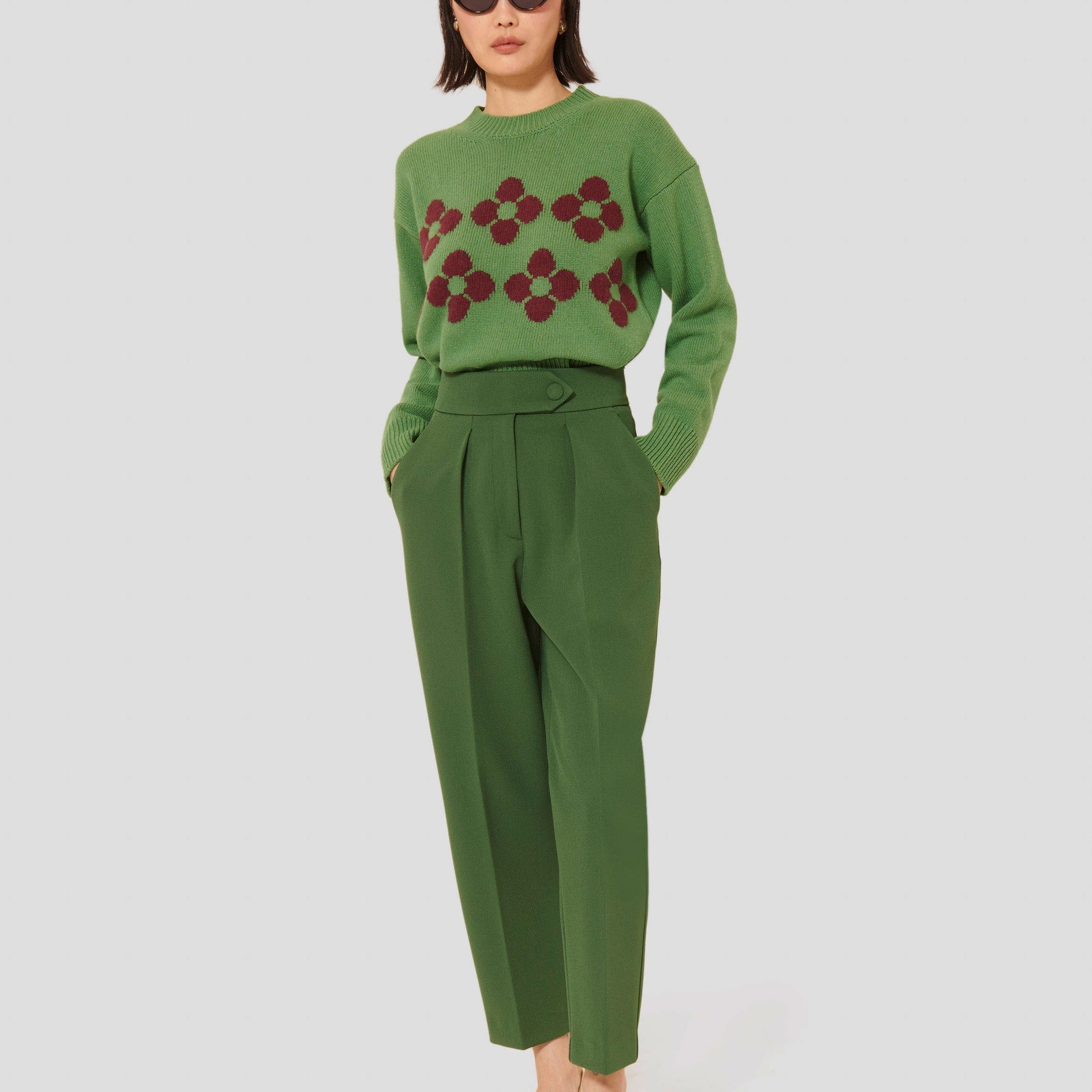 Tara Jarmon model wearing green crepe pants, with a light green sweater.