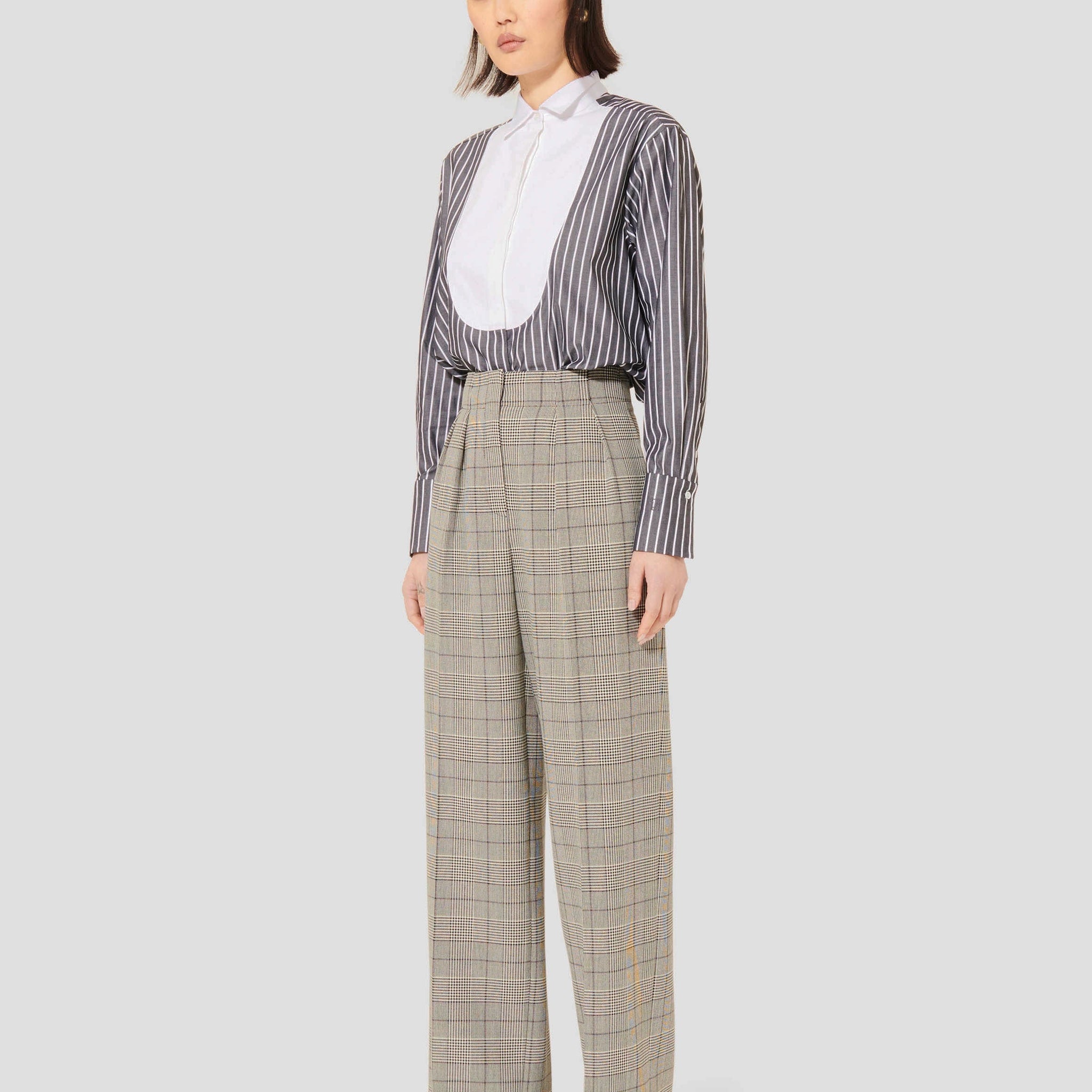 Model wearing Tara Jarmon grey plaid pants.