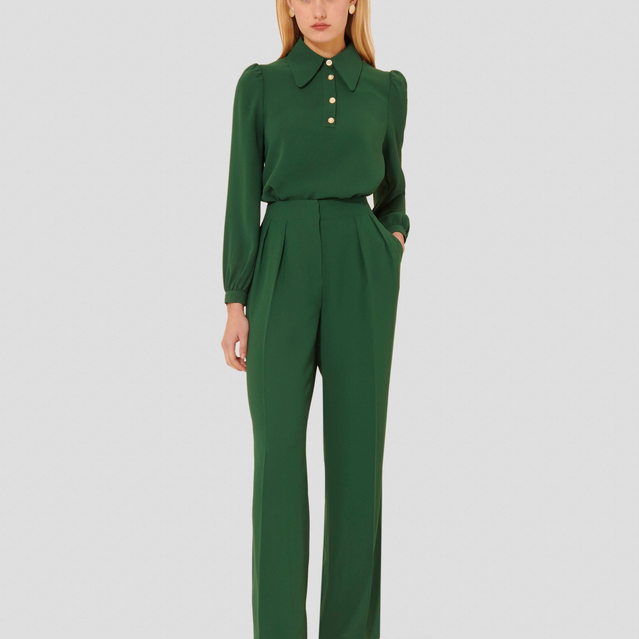 Model wearing Tara Jarmon green crepe pants. 