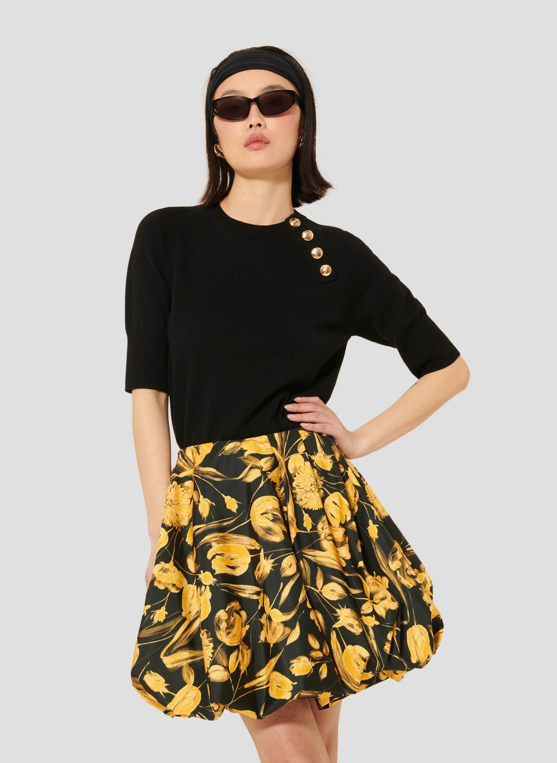 Women's Soft Wool Black Sweater with Round Collar, Short Sleeves, and Gold Buttons.