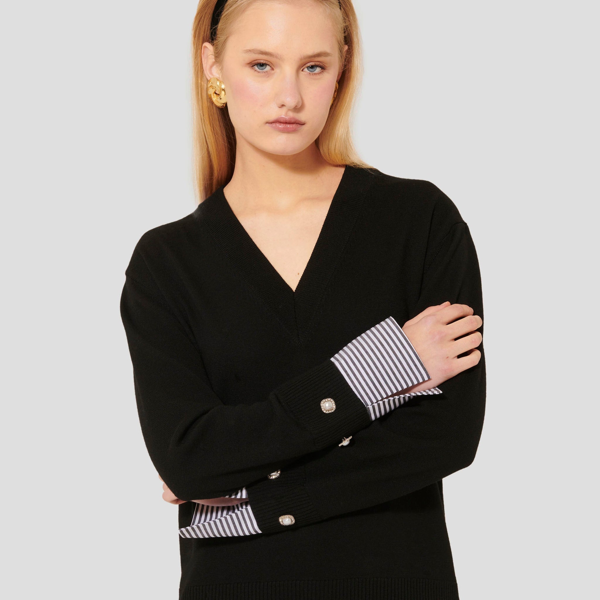 Luxurious Merino Wool Top in Black with Striped Cuffs and Jewel Button Detail.