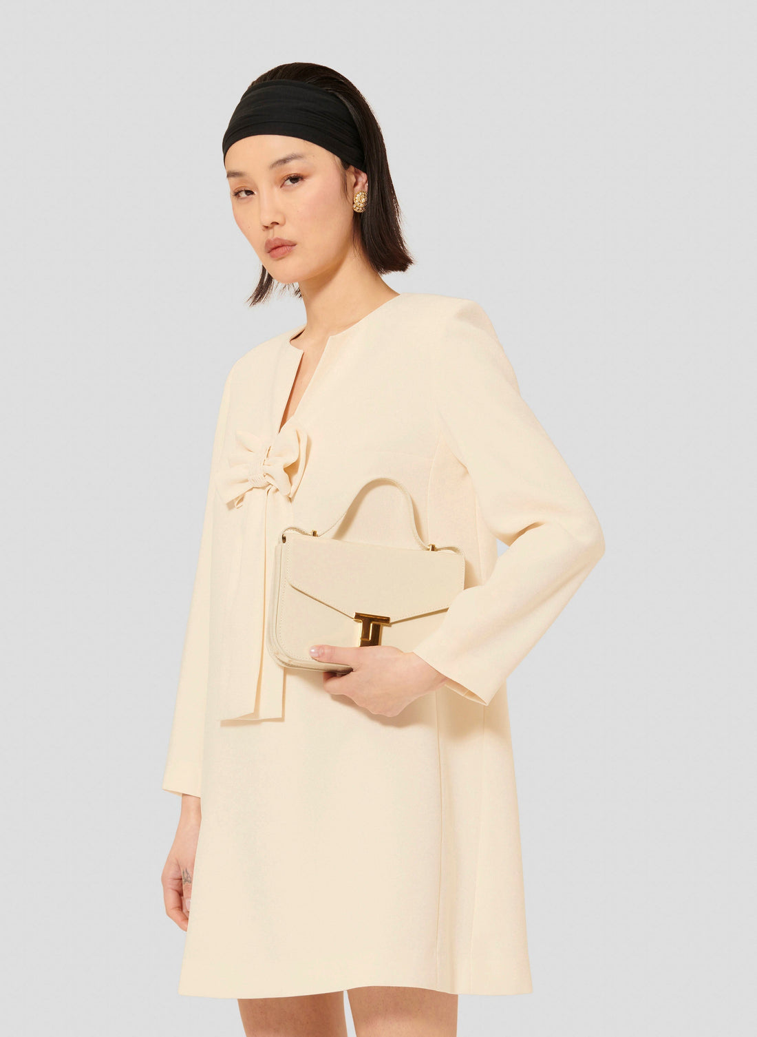 Short ecru crepe dress with long sleeves and V neckline. 
