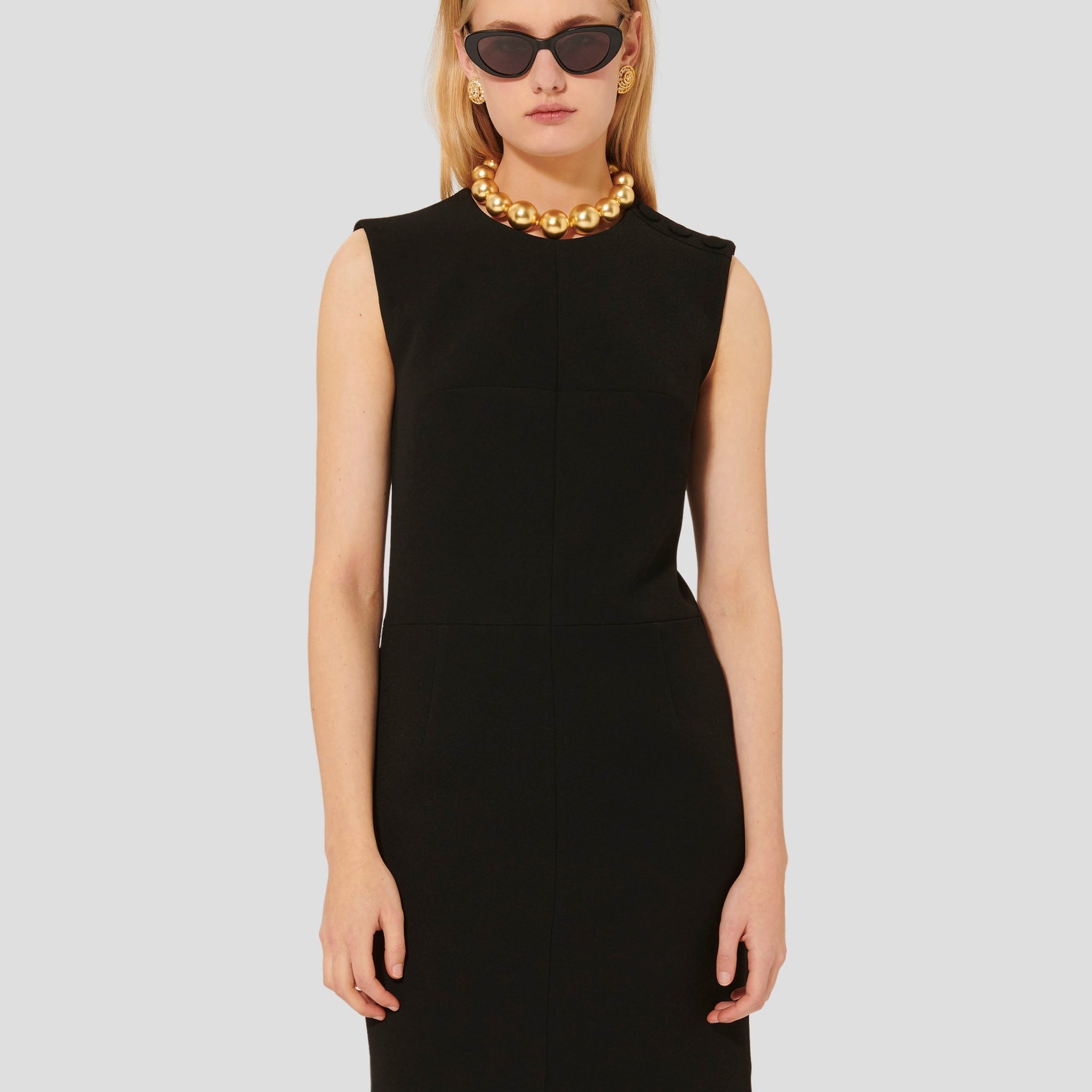 Model wearing Tara Jarmon short black crepe dress. 