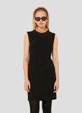 Model wearing Tara Jarmon short black crepe dress. 