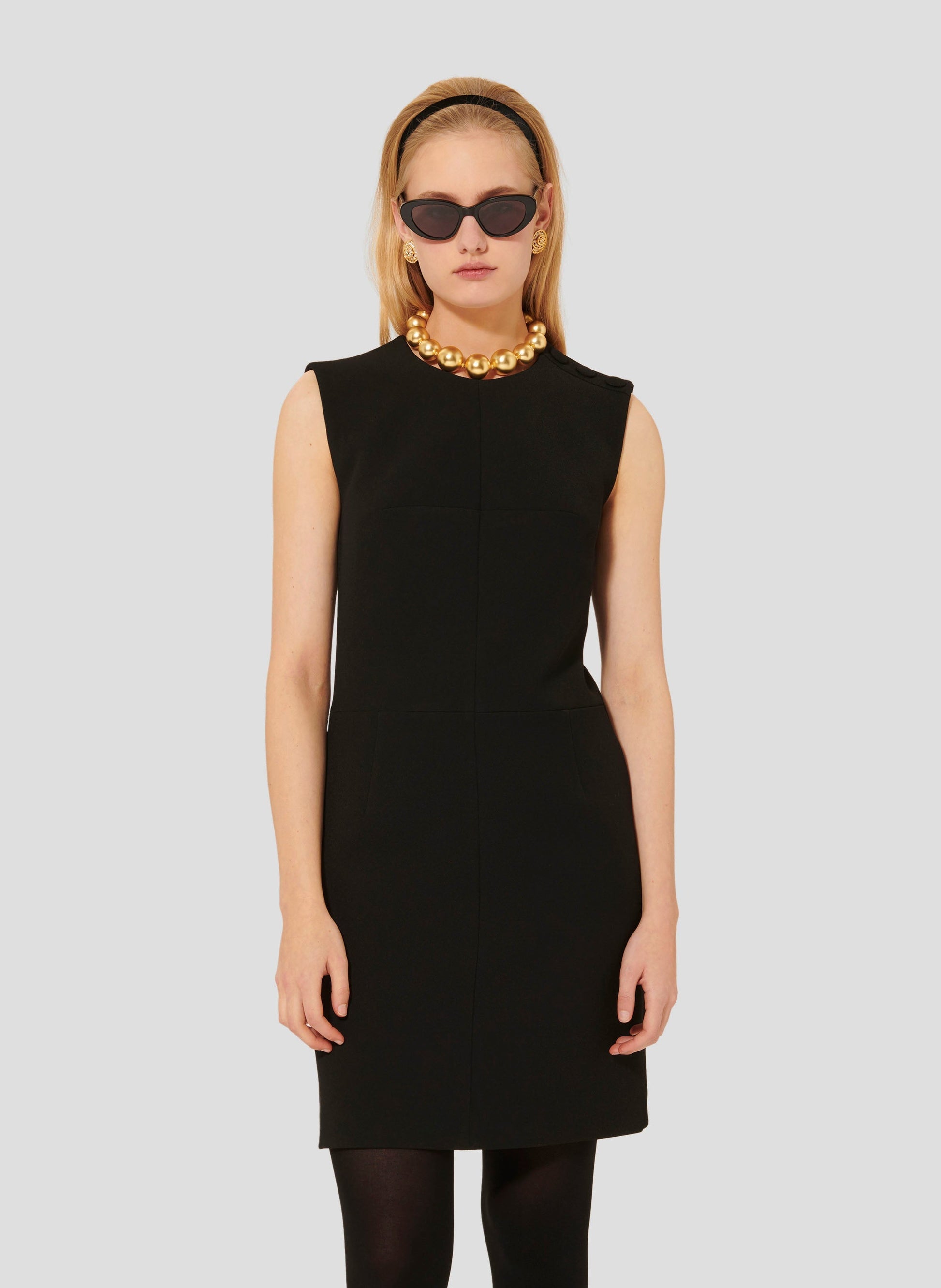 Model wearing Tara Jarmon short black crepe dress. 