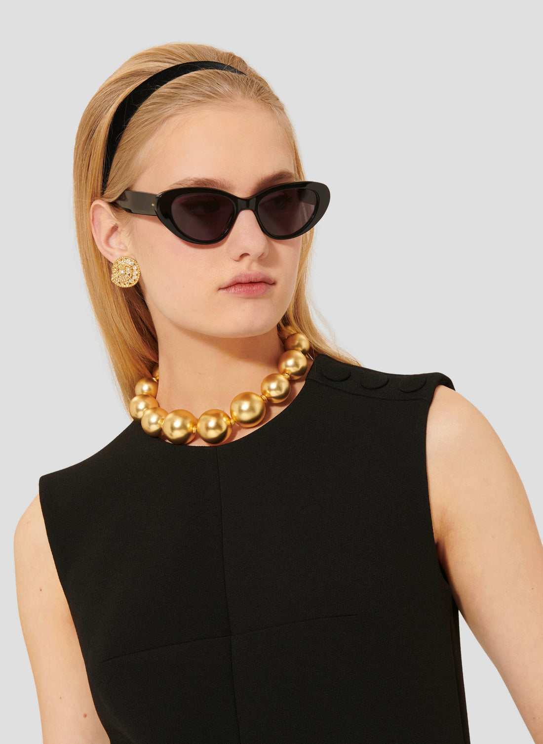 Model wearing Tara Jarmon short black crepe dress. 