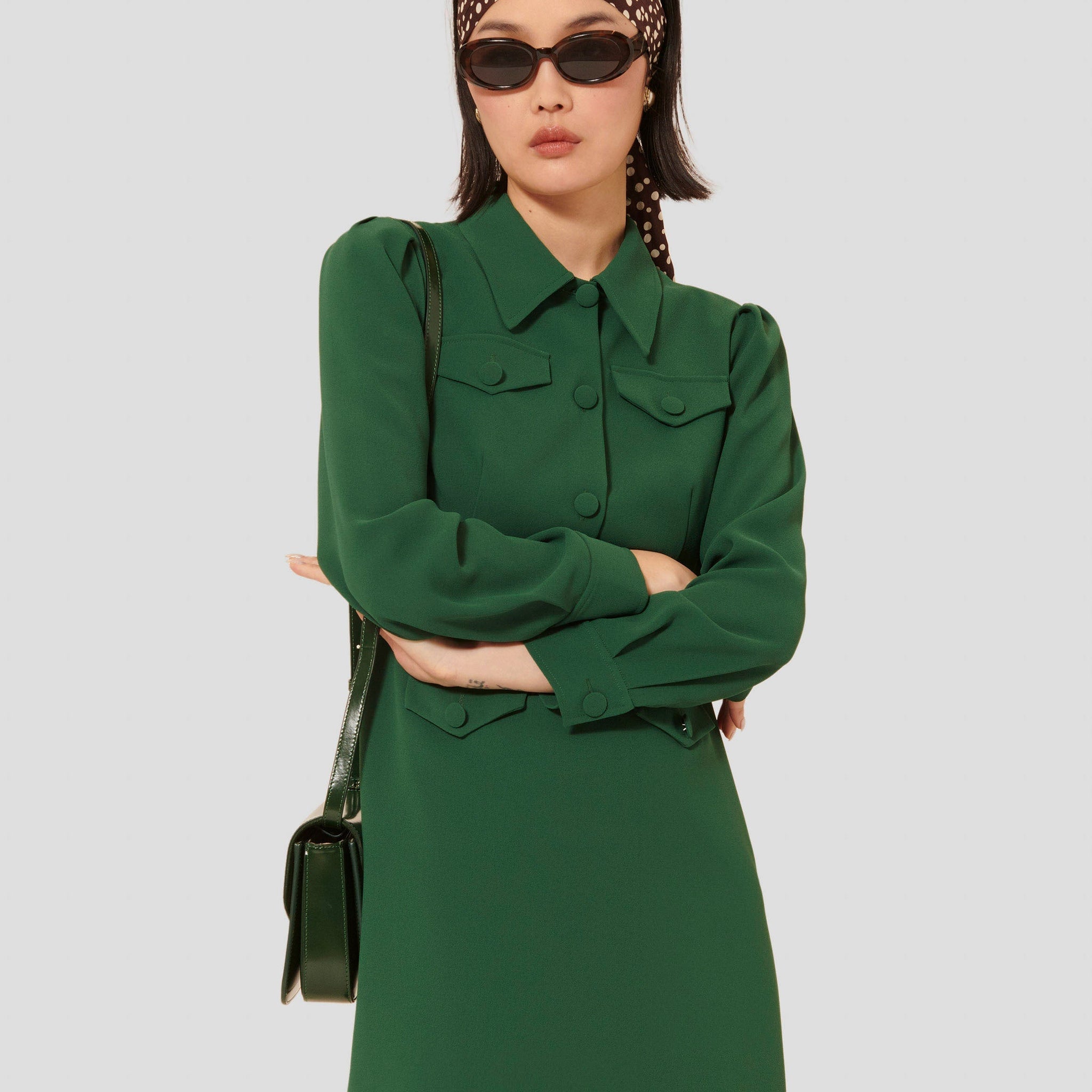 Model wearing Tara Jarmon short green crepe dress with shirt collar.