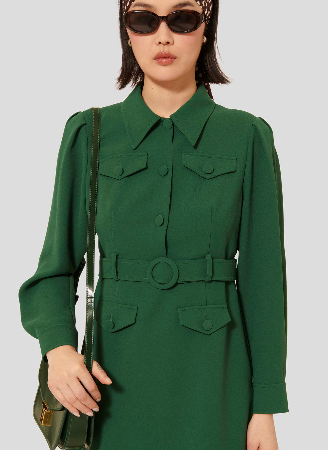 Model wearing Tara Jarmon short green crepe dress with shirt collar.