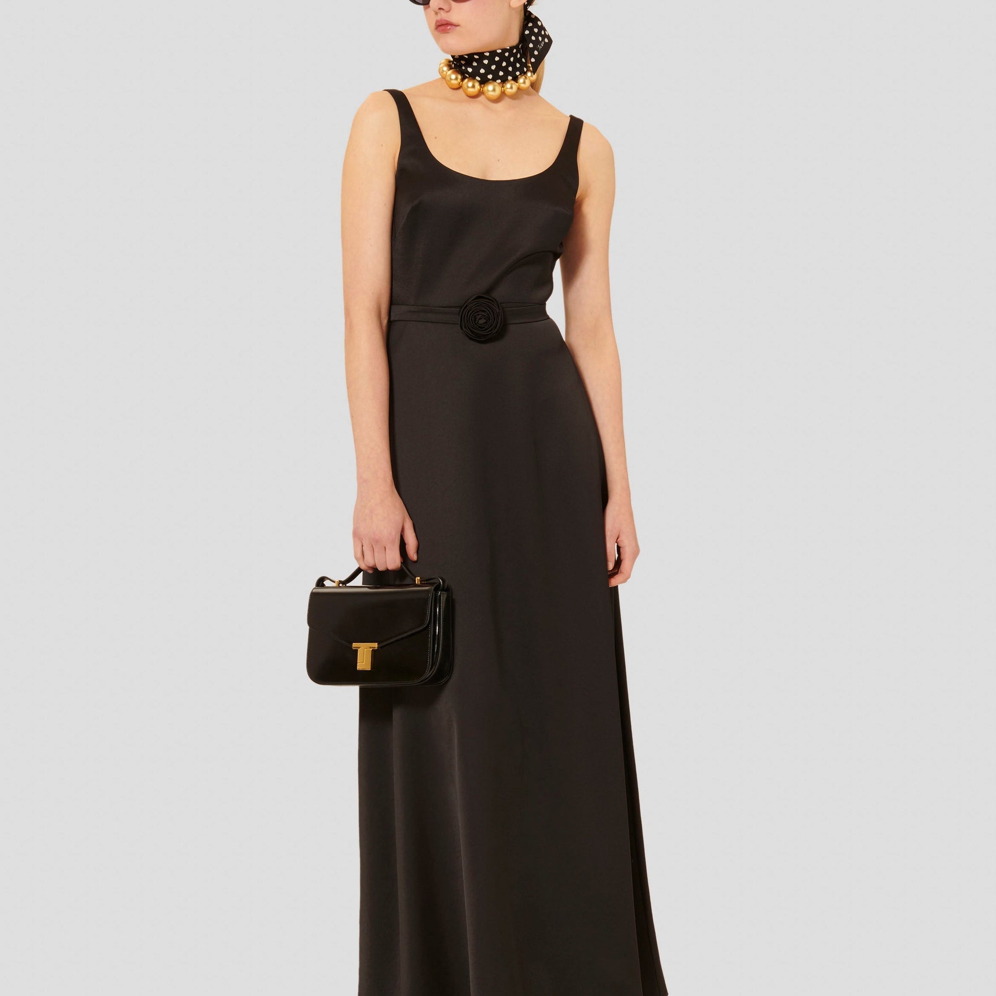 Sleeveless long satin black dress with round neckline and invisible zip.