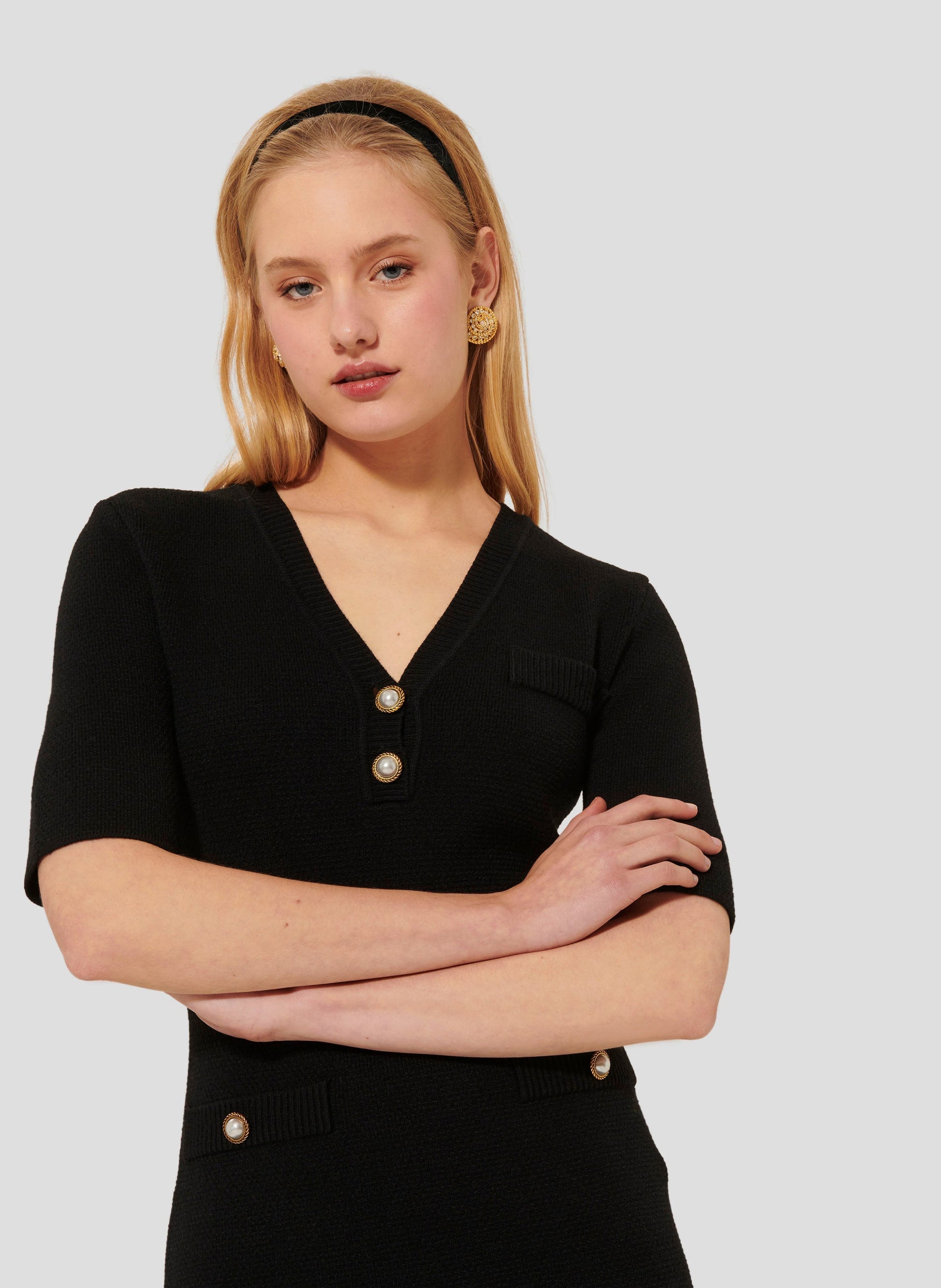 Black Fitted Knit Dress with Side Pockets and Pearl Buttons. 