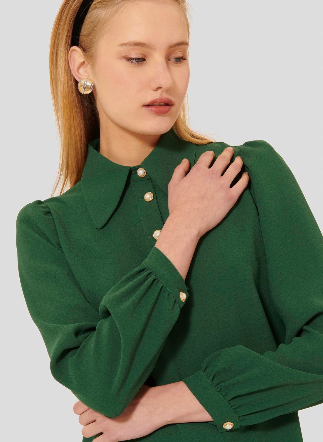Model wearing Tara Jarmon green crepe top with long balloon sleeves. 