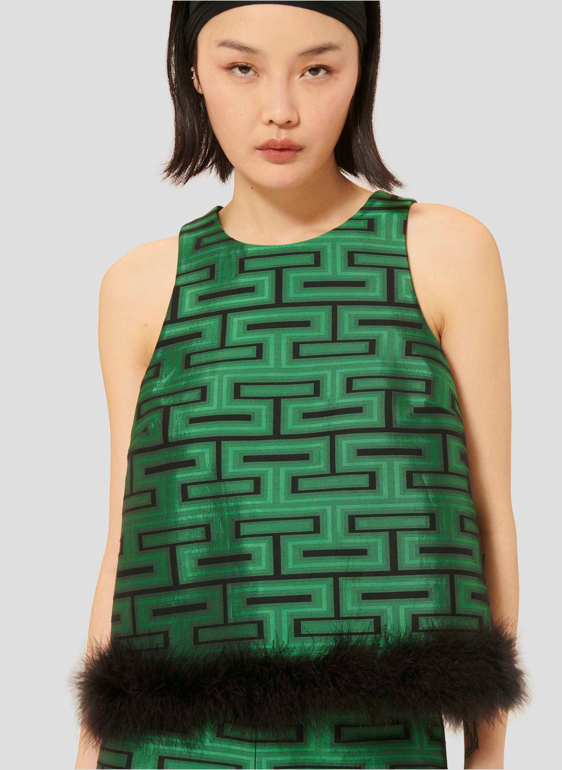 Model wearing Tara Jarmon Sleeveless Top in Emerald Green with Fur Detail.