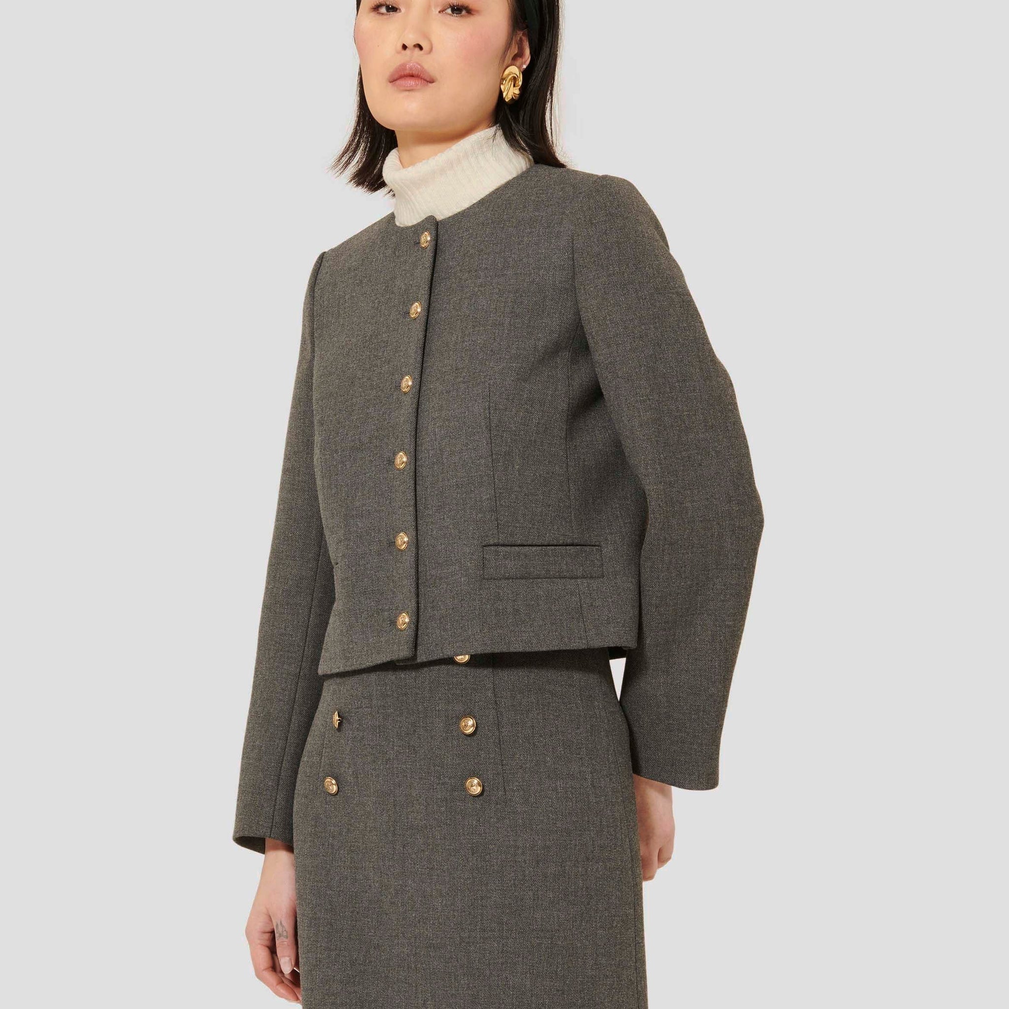 Model wearing Tara Jarmon Grey Canvas Jacket with Round Neckline and Button Closure.