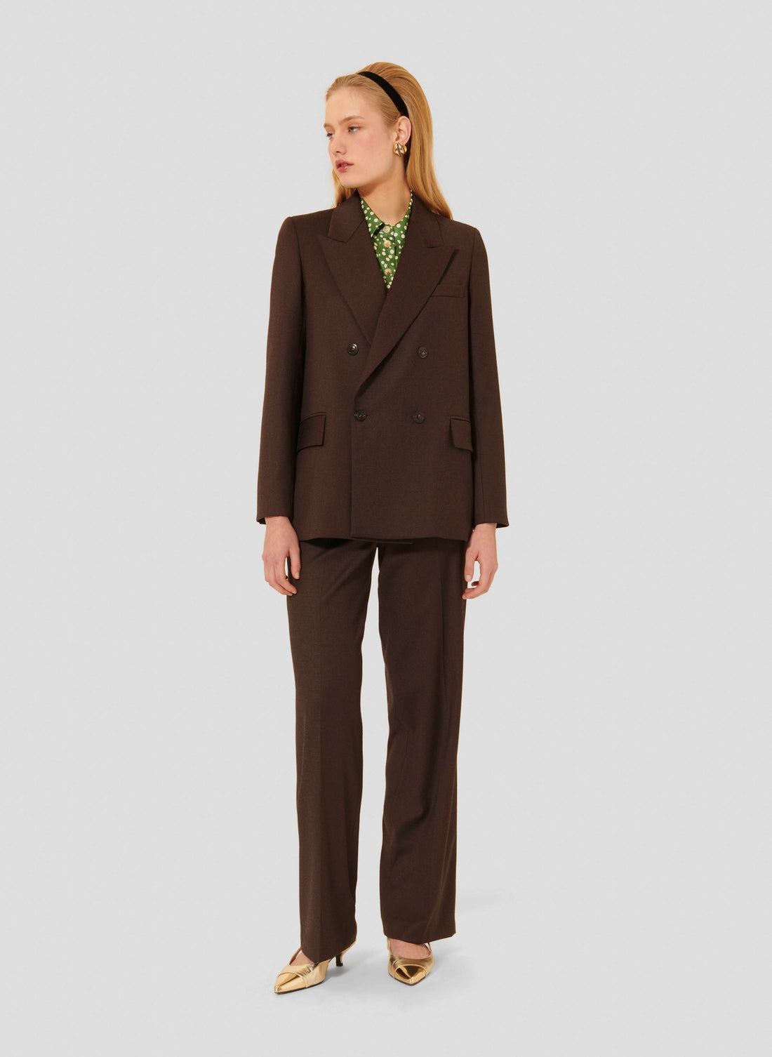 Model wearing Tara Jarmon brown suit Jacket with buttoned cuffs. 