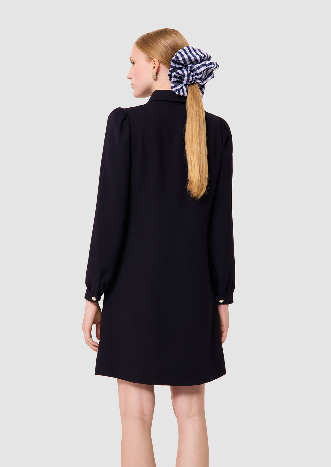 Woman wearing a Rolfo midnight blue crepe dress from Tara Jarmon Lebanon on a white background 