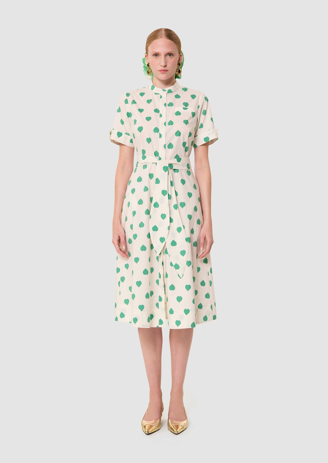 Woman wearing Ricochet green hearts print dress from Tara Jarmon Lebanon on white background
