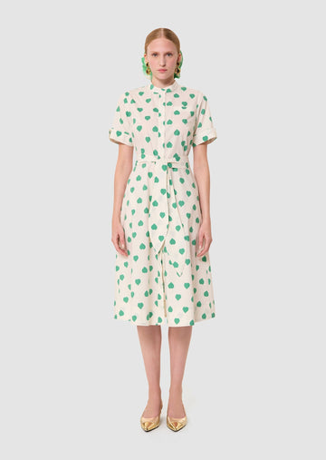 Woman wearing Ricochet green hearts print dress from Tara Jarmon Lebanon on white background