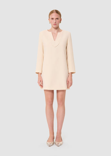 Woman wearing a light-colored ecru dress from Tara Jarmon Lebanon 