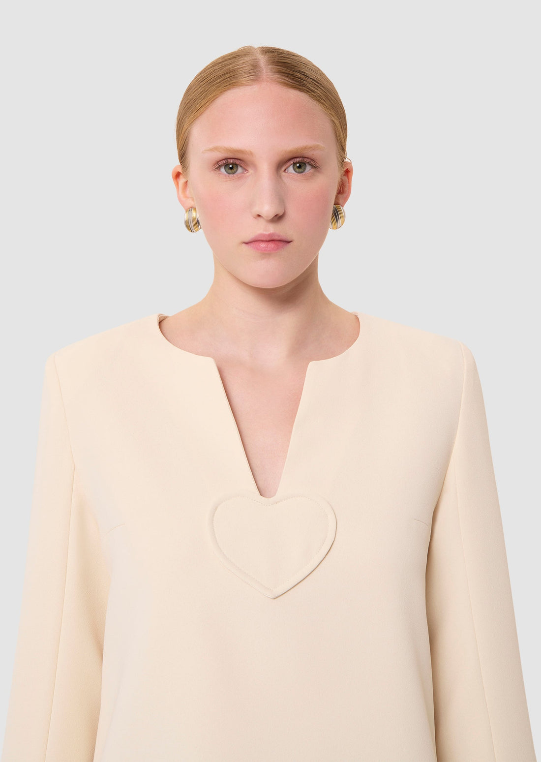 Woman wearing a light-colored ecru dress from Tara Jarmon Lebanon 