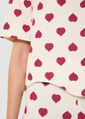 Blouse with red heart pattern on a white background