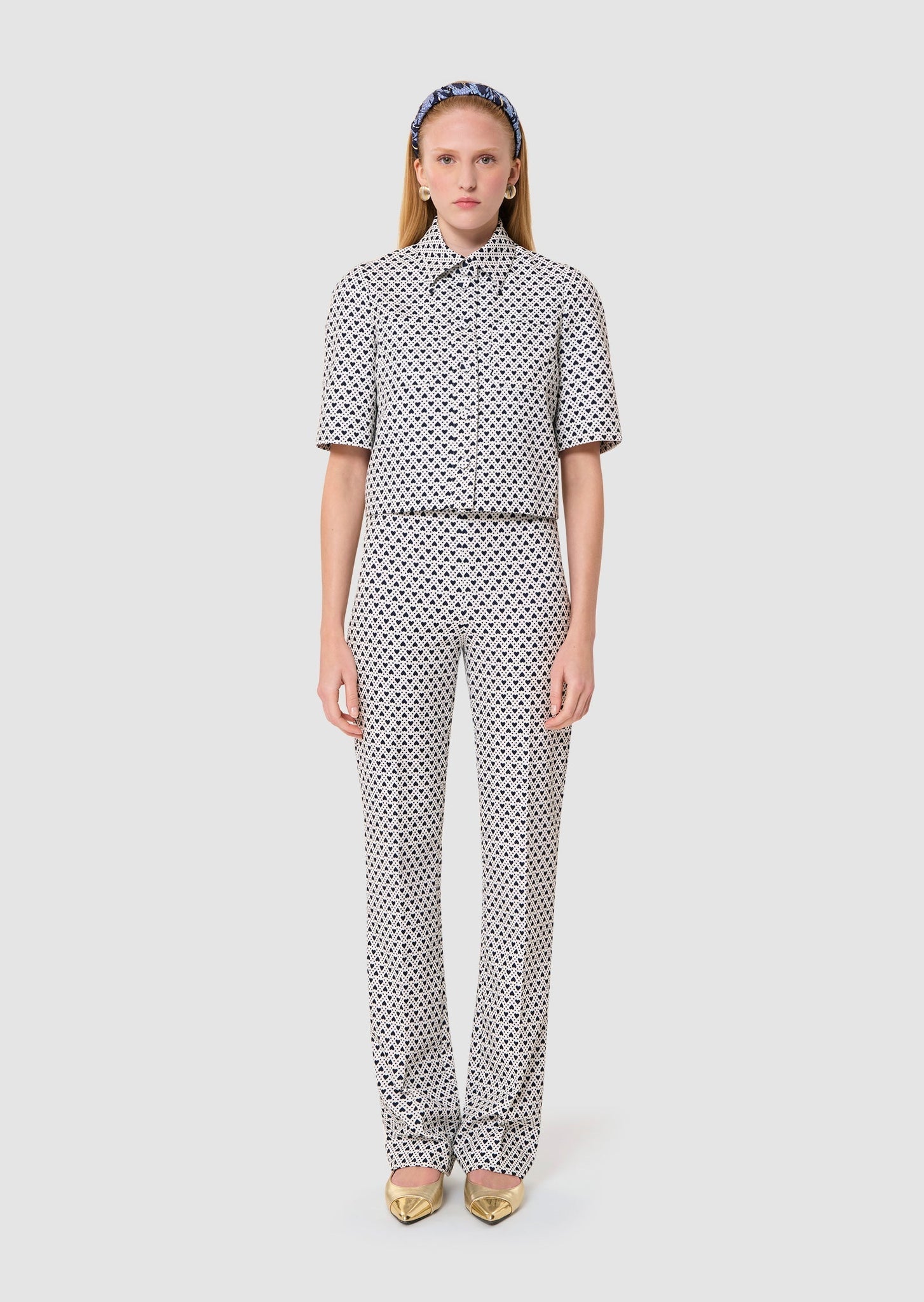 Woman wearing a polka dot outfit on a white background