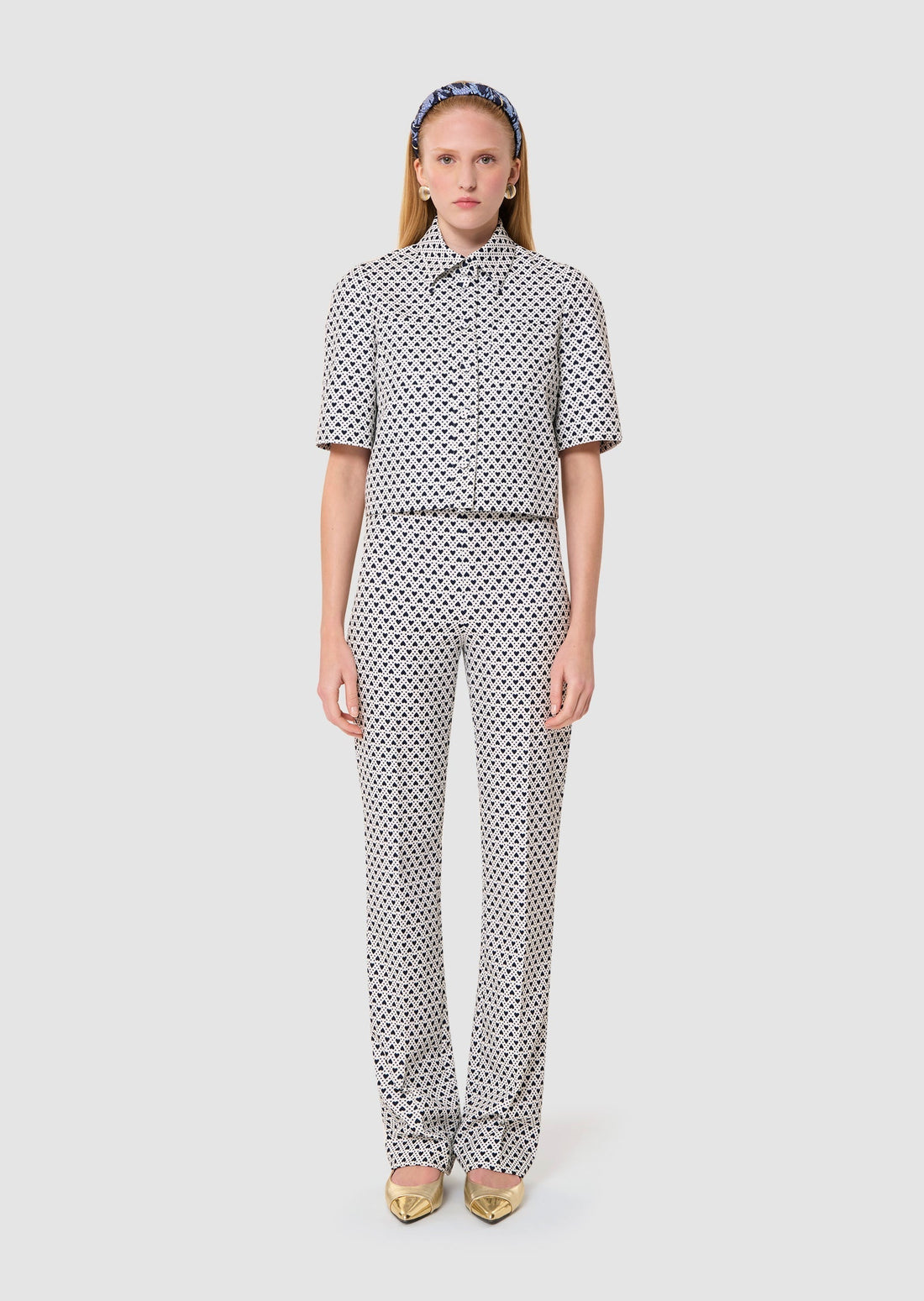 Woman wearing a polka dot outfit on a white background