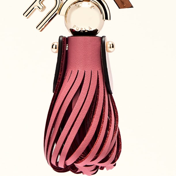 Pink tassel keychain with brown leather strap on a white background